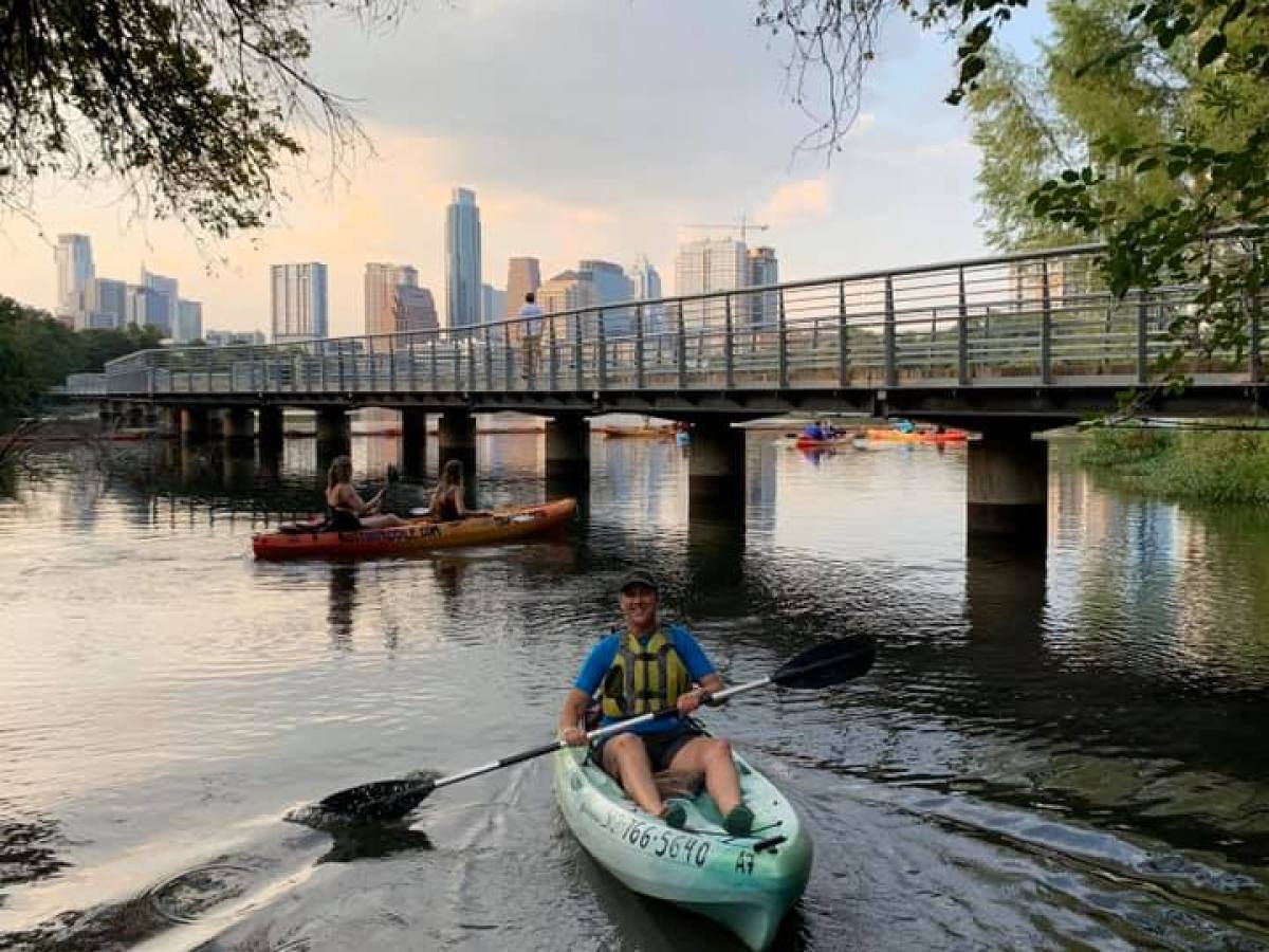 a boat traveling along a river next to a body of water