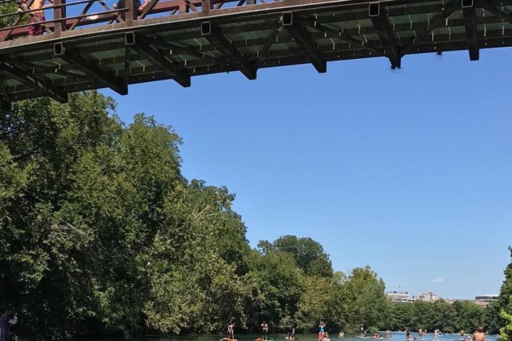 a train crossing a bridge over a body of water